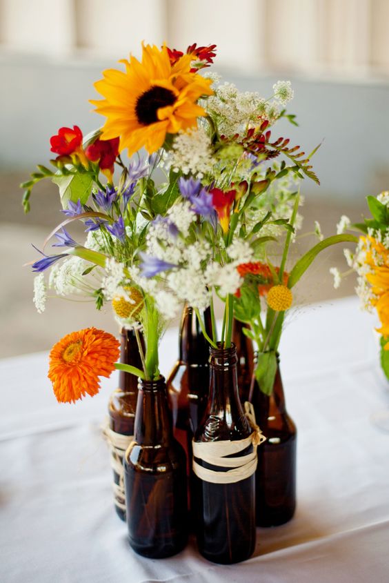 beer bottle vases – for DIY bbq wedding center pieces. wrap with twine or jute