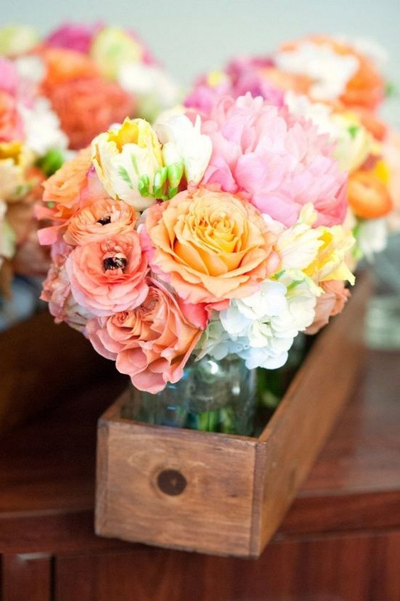 Arrangements of pastel roses, camellias & tulips wedding centerpiece
