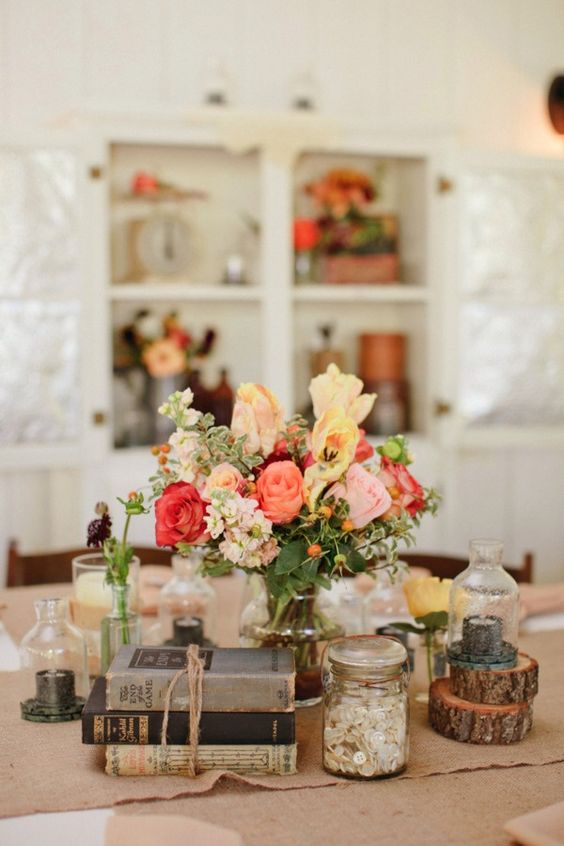 Burlap, mason jars and books for center pieces