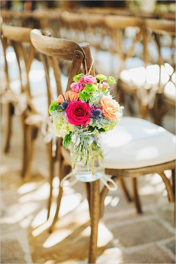 Farm Chairs with a padded cushion and mason jars filled with flowers