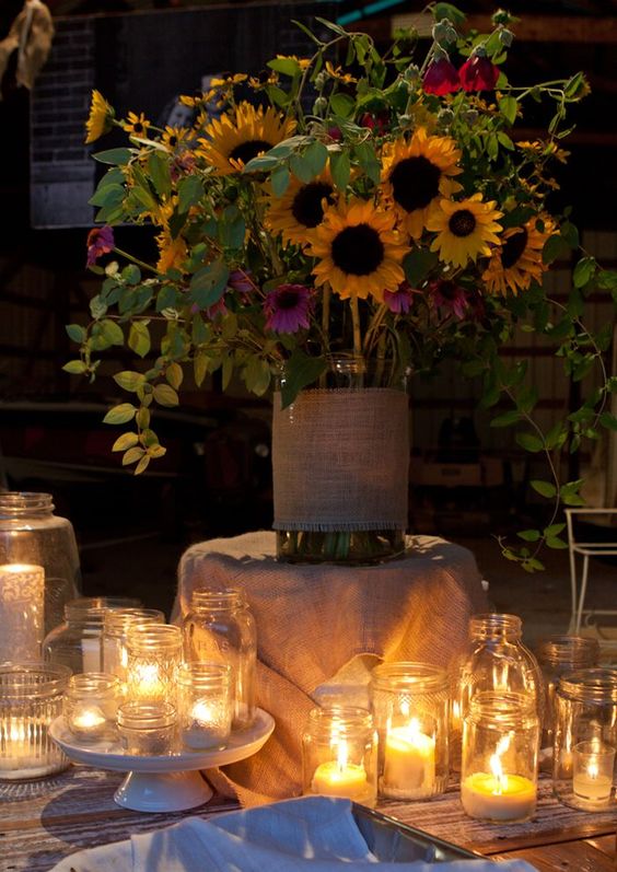flower arrangement and candles in jars