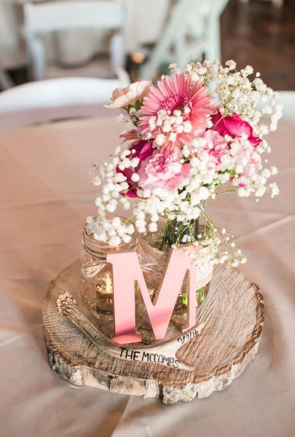 rustic treen stump and pink flowers wedding centerpiece