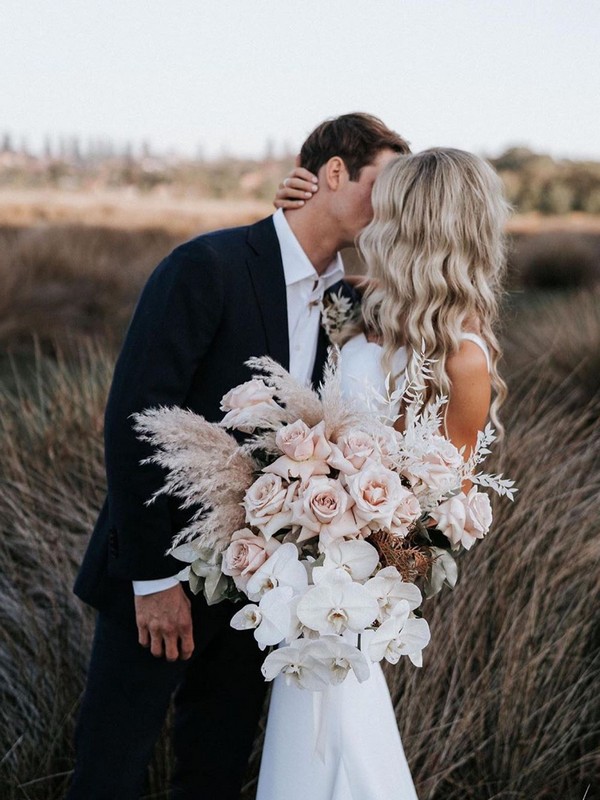 white and blush roses and pampas grass wedding bouquet